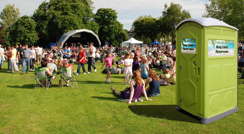 Key Lime Portable Restroom | Key Lime Portable Toilet shown at an outdoor music festival in the summer.