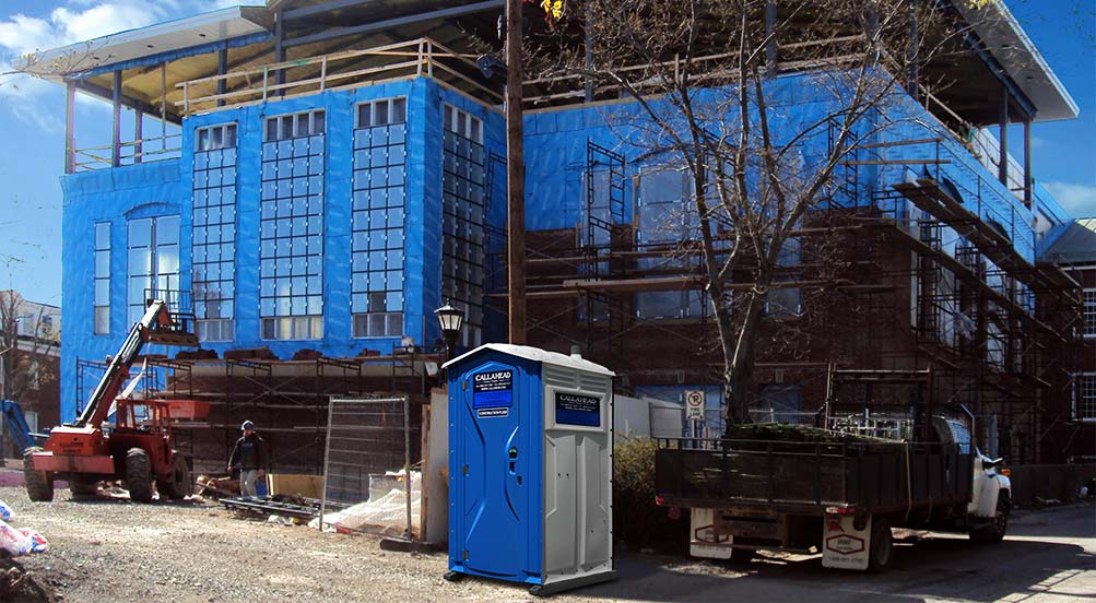 The Blue And White Construction Flush Portable Toilet At A Job Site