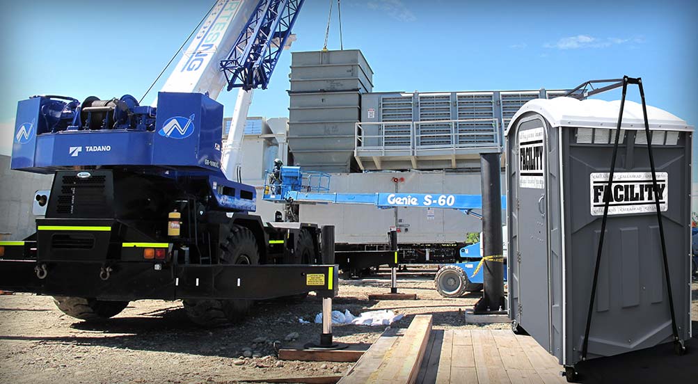 The FACILITY Porta Potty At a Jobsite, Next to a Crane