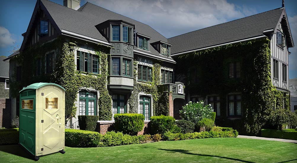 The VINTAGE Portable Restroom shown in front of Large, Upscale Residence with Ivy Covered Exterior