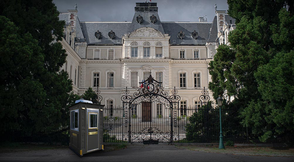 Guard Booth | The Guard Post 16 with a grey color, in front of a gated three story mansion in New York.