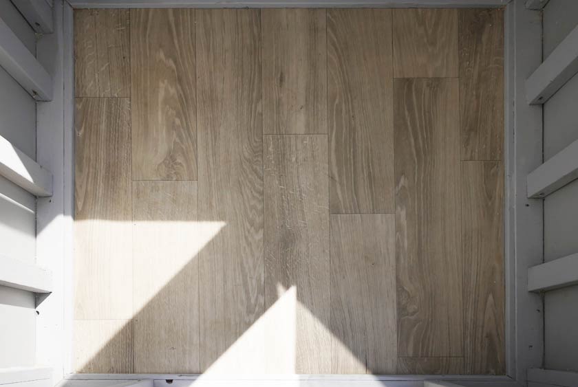 THE FLOORING IS A WIDE PLANK FAUX WOOD OR FAUX TILE FLOOR BY ARMSTRONG