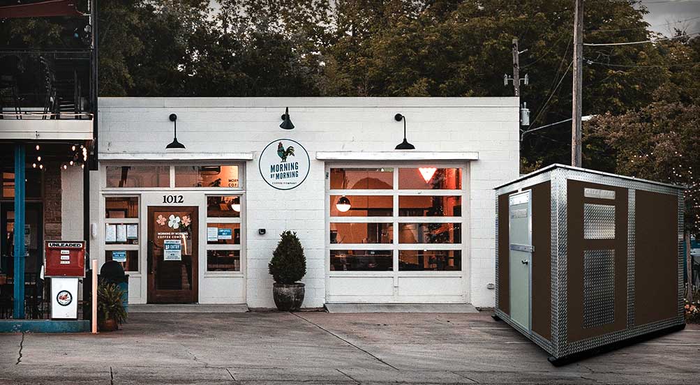 A BROWN A48 STORAGE SHED IN FRONT OF A RURAL GAS STATION