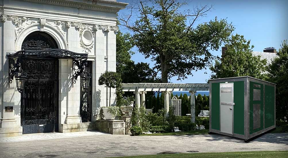 A GREEN A48 STORAGE SHED BEING USED AT AN ESTATE'S GARDEN