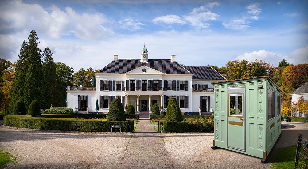 A Green Valet Key Booth 48 in Front of a Large Estate