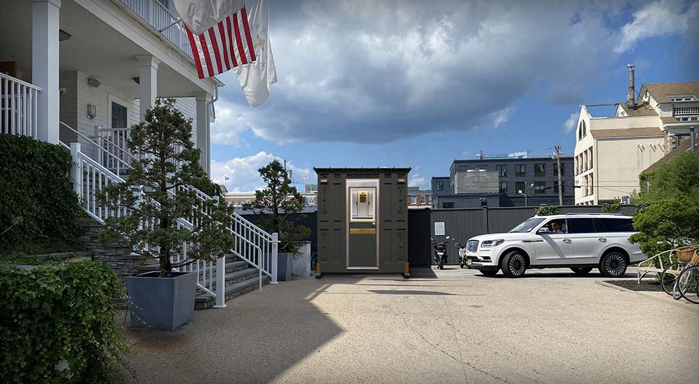 A Grey Valet Key Booth 48 Outside of a Hotel
