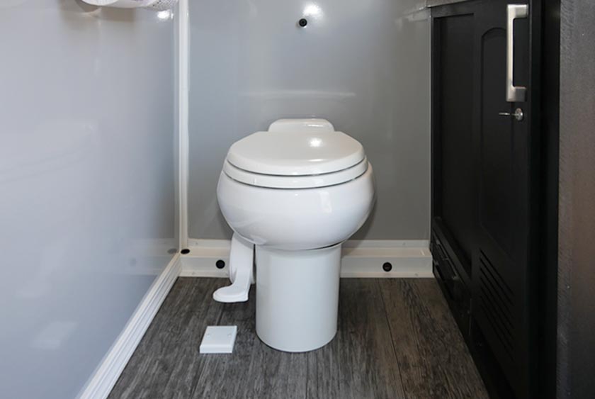 PORCELAIN TOILET IS FOOT-FLUSH ACTIVATED