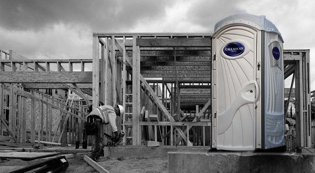 A White Toilet Portable Restroom Near Jobsite