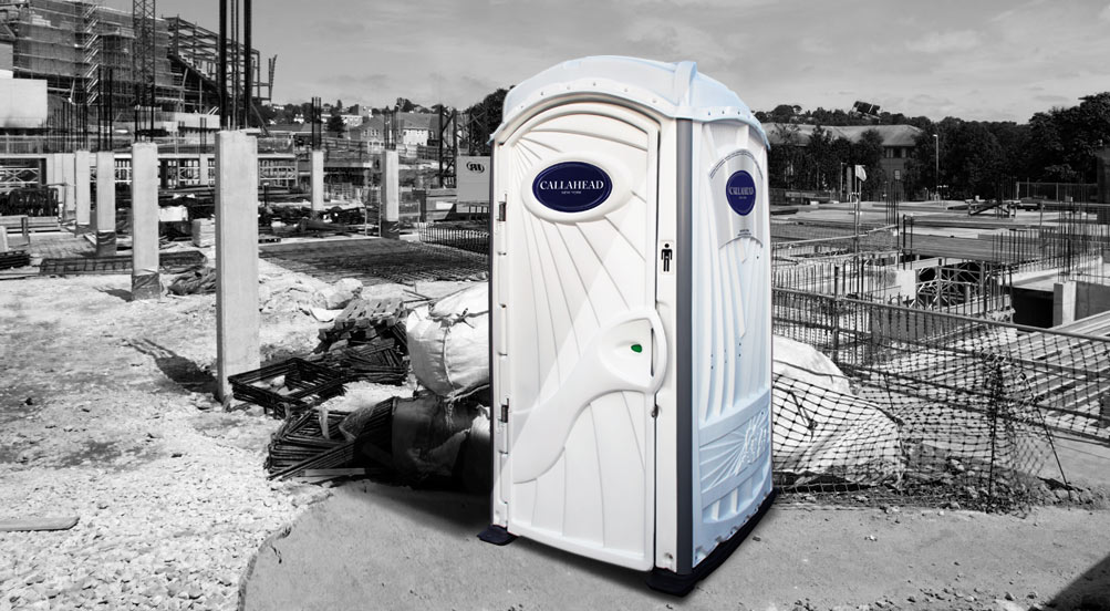 A White Toilet Portable Restroom Near Industrial Park