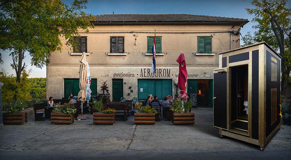 Porterhouse 25 Portable Restroom at a Restaurant with Outdoor Seating at Twilight