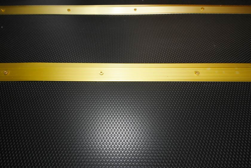 NON SLIP BLACK FLOORING FINISHED WITH GOLD TRIM