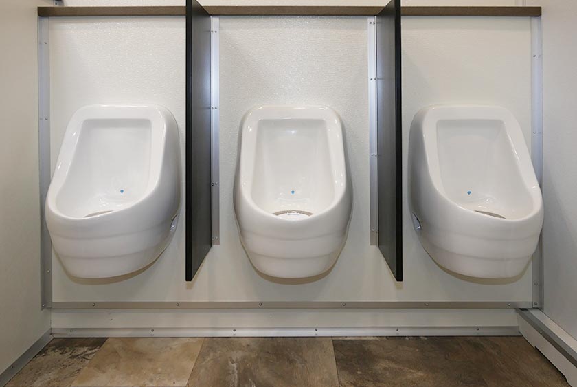 THREE PORCELAIN URINALS ON THE MEN'S SIDE