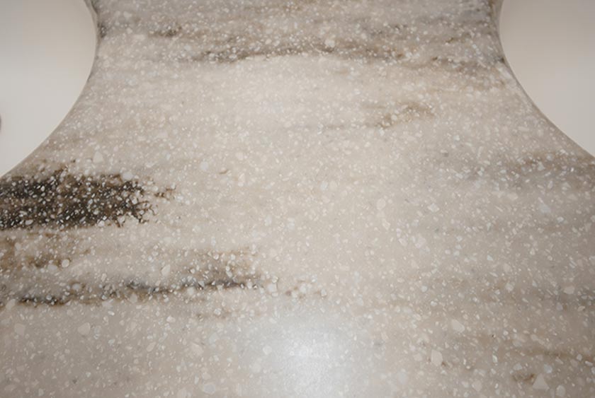 VANITY SINK AREA HAS CORIAN COUNTERTOPS