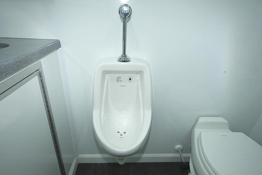 PORCELAIN URINAL INSIDE ONE OF THE BATHROOMS