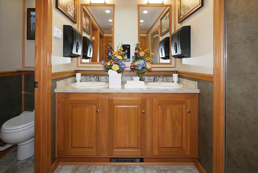 BEAUTIFUL VANITY AREA WITH LARGE MIRROR AND HAND TOWEL DISPENSERS 