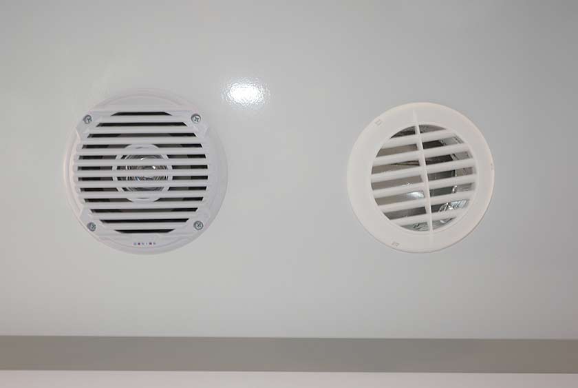 CENTRAL MUSIC SYSTEM HAS AM/FM RADIO AND CD PLAYER WITH CEILING INSTALLED SPEAKERS