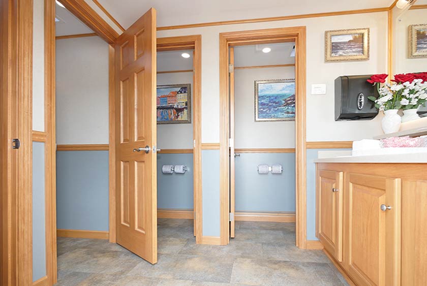 WOMEN'S BATHROOM CONTAINS FOUR PRIVATE STALLS WITH FLOOR TO CEILING LOCKABLE DOORS