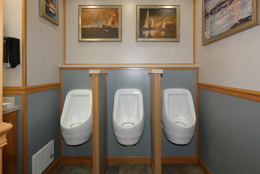 THREE PORCELAIN URINALS ON THE MEN'S SIDE