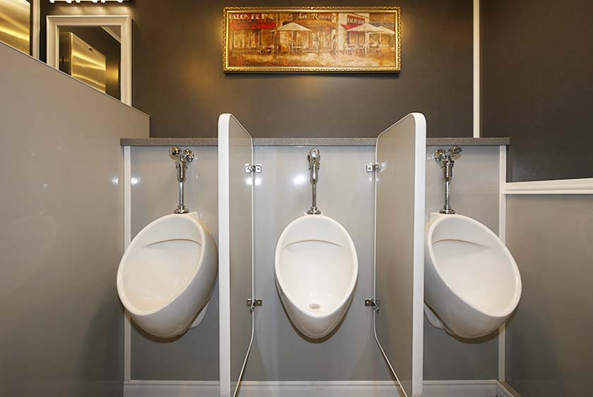 THREE PORCELAIN URINALS WITH PRIVACY DIVIDERS