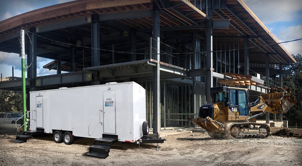 The PLANDOME Restroom Trailer By A Construction Site 
