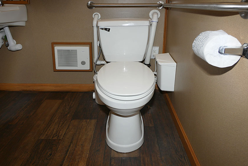 FULL SIZED ADA COMPLIANT PORCELAIN FLUSHING TOILET WITH MACERATOR