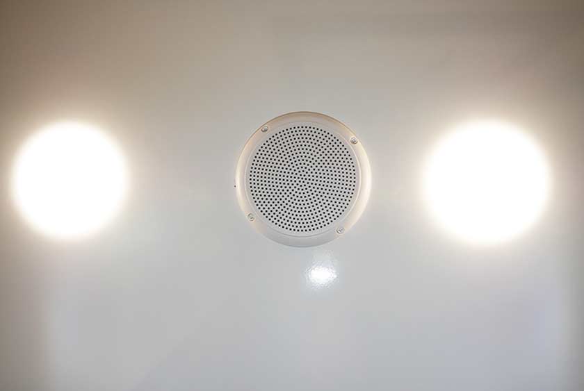 CENTRAL MUSIC SYSTEM WITH CEILING MOUNT SPEAKERS AND MODERN LED LIGHTING