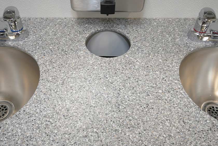 CONVENIENT TRASH RECEPTACLE WITHIN THE VANITY COUNTERTOP