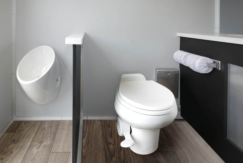 MEN'S SIDE INCLUDES PORCELAIN TOILET, ODORLESS URINAL, SEPARATED BY A PRIVACY DIVIDER