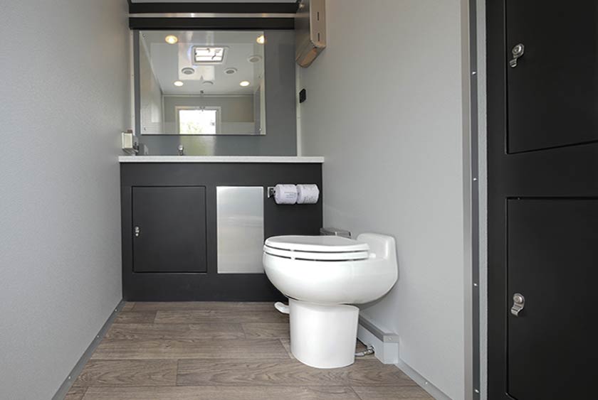 WOMEN'S SIDE WITH PORCELAIN TOILET, VANITY WITH STAINLESS SINK AND MIRROR