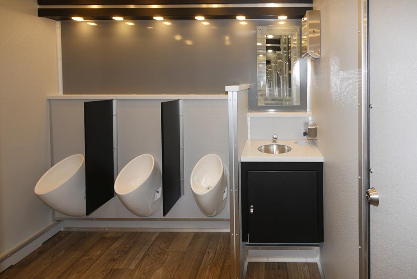 THREE URINALS ON MEN'S SIDE WITH ONE OF THE 2 SINK VANITIES