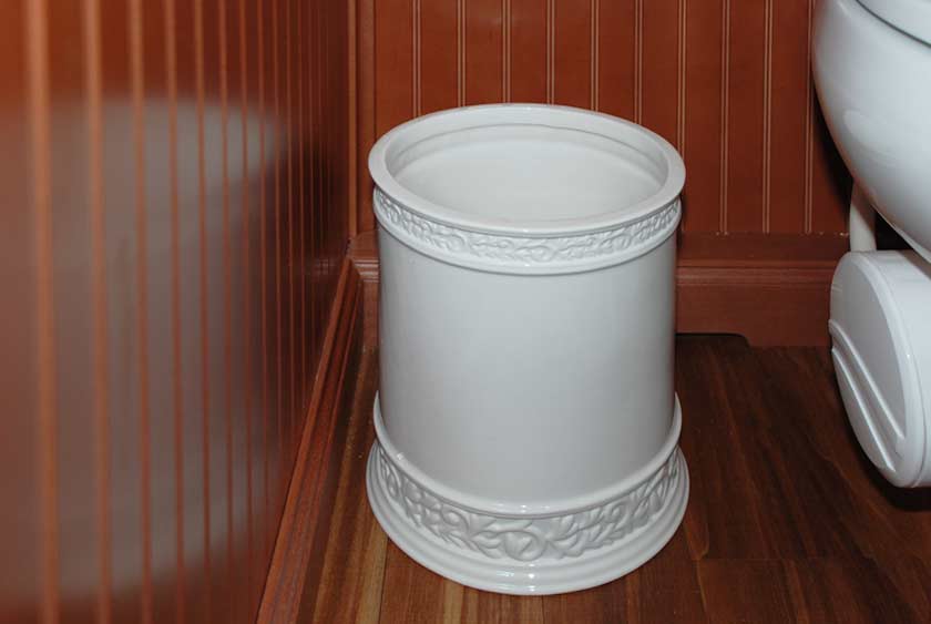 DETAILED PORCELAIN WASTE BASKETS INSIDE STALLS