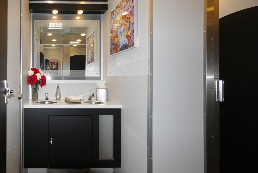 SOPHISTICATED FOYER SHOWCASES THE DOUBLE SINK VANITY WITH OVERSIZE MIRROR