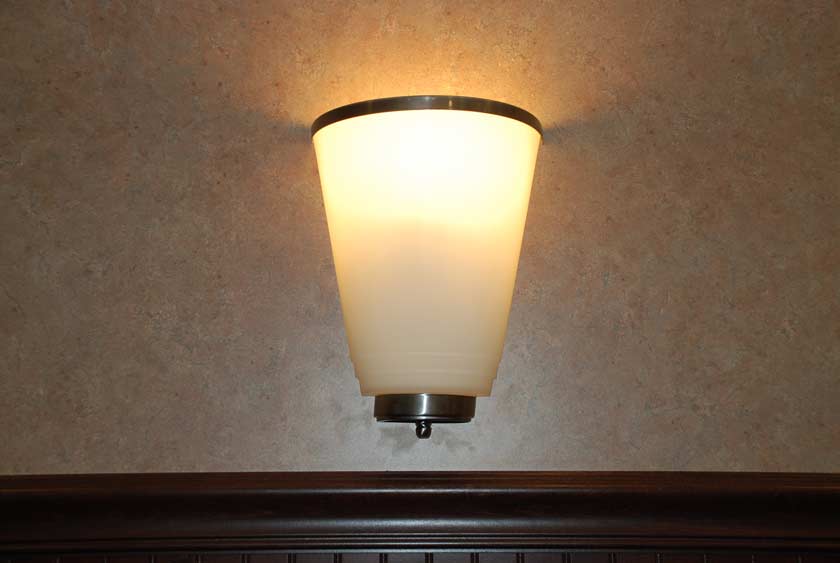 ELEGANT SCONCES ILLUMINATE THIS LUXURY RESTROOM TRAILER