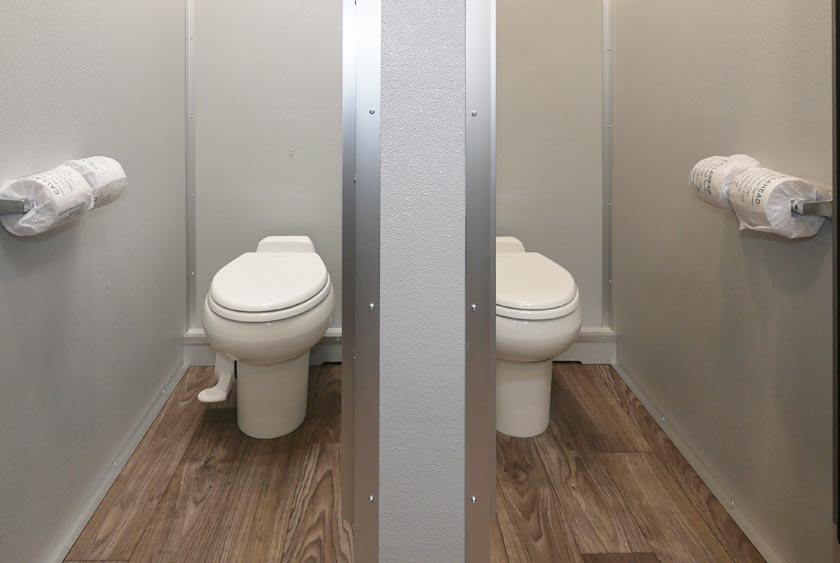 COMFORTABLE TOILET STALLS IN EACH SECTION OF THIS BATHROOM TRAILER