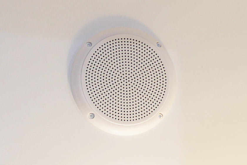 CEILING MOUNT SPEAKERS POWERED BY CENTRAL CD PLAYER AND AM/FM STEREO SYSTEM