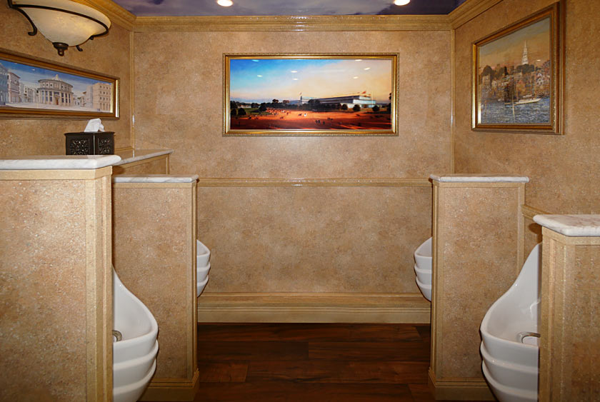 FOUR URINALS WITH PRIVACY DIVIDERS THAT ARE CAPPED WITH CALCUTTA MARBLE