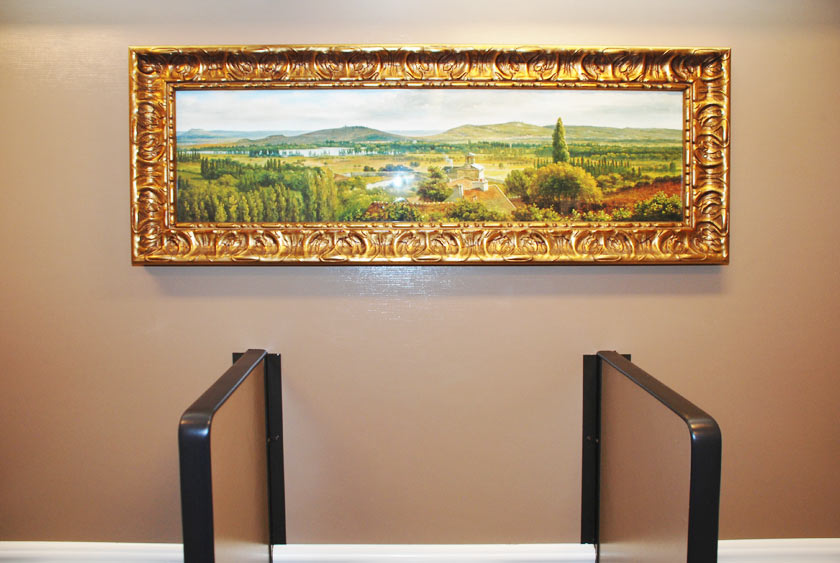 FRAMED ARTWORK OVER MEN'S URINALS