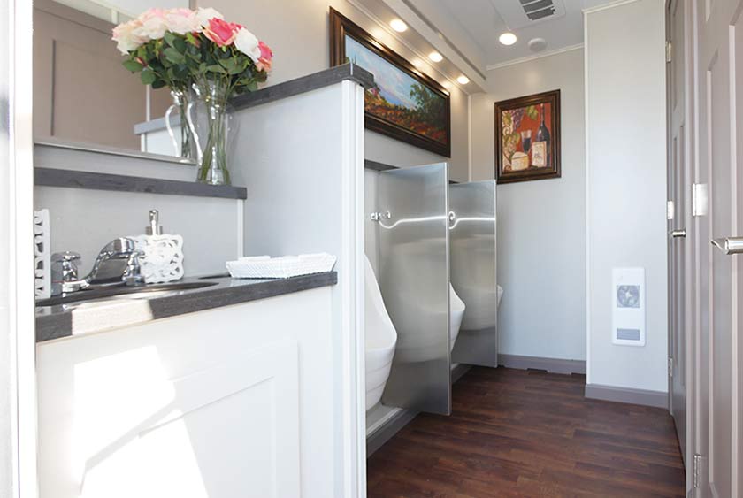 MEN'S SIDE VANITY, PRIVACY DIVIDER AND THREE SLOAN PORCELAIN WATERLESS URINALS