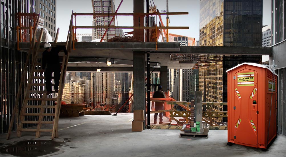 The Safety Head Portable Restroom In A building Site